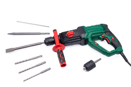 Hammer drill with a set of drill bits isolated on a white background.の写真素材