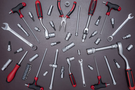 Set of various auto mechanic tools on a working table.