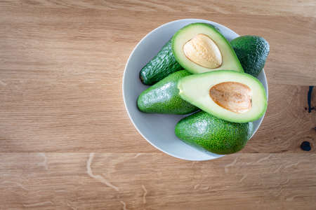 Green avocado on a wooden