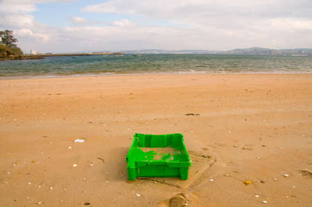 OLEIROS, SPAIN - MARCH 21, 2016: Box fish abandoned on the beach for the sea.の写真素材