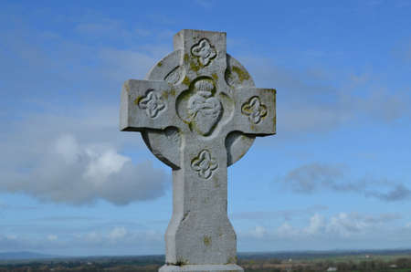 Fancy stone cross standing against the sky.の写真素材