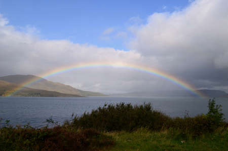 Captivating view of a full rainbow in the waters in Scotland 