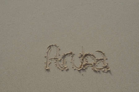 Smooth damp beach sand with Aruba written in it.の写真素材