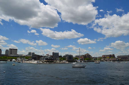 A look at the City of Boston from the harbor on a summer day.の写真素材