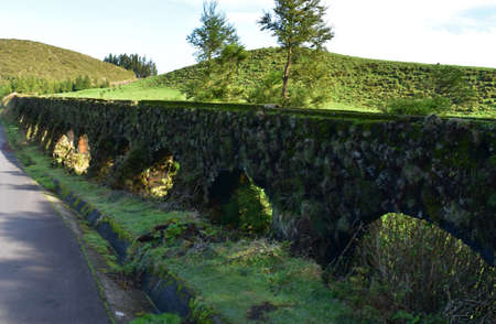 Fantastic scenic view of moss covered aqueduct in the Azores.