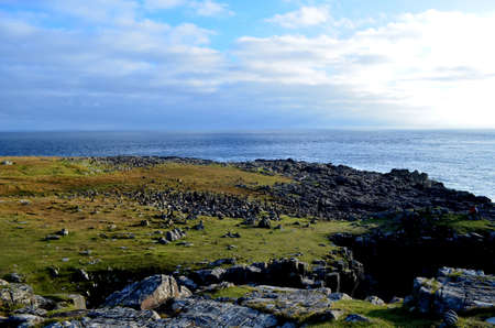 Black rocks on the coast of Neist Point in Scotland.の写真素材