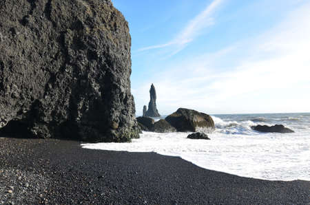 Beautiful black lava rock and sea stacks on Reynisfjara beach.