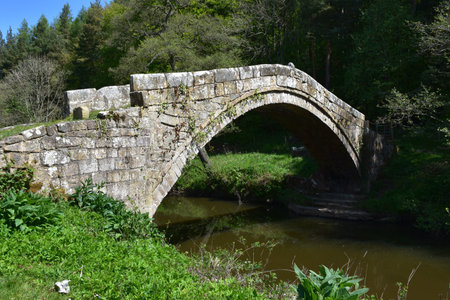 Historic look at Beggar's bridge over the river Esk in Glaisdale England.の写真素材