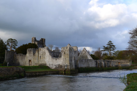 Ruins of Desmond Castle with dark storm clouds above it.