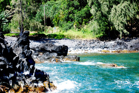 Beautiful tropical ocean waters crashing on lava rock.の写真素材