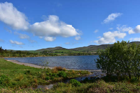 Ennerdale water resevoir surrounded by rolling hills on a beautiful spring day.