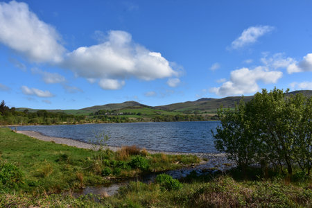 Rolling hills and farmland surrounding Ennerdale Water resevoir in Northern England.の写真素材