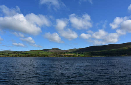 Ennerdale Water resevoir surrounded by rolling hills and fells in the spring.