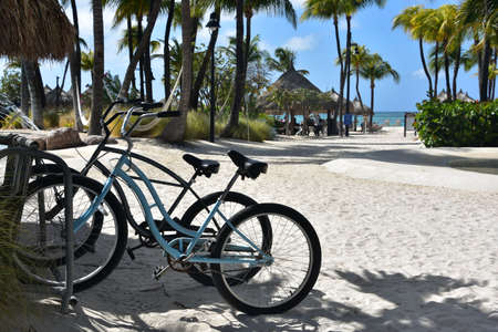 Two bikes parked in the sand on a beach.の写真素材