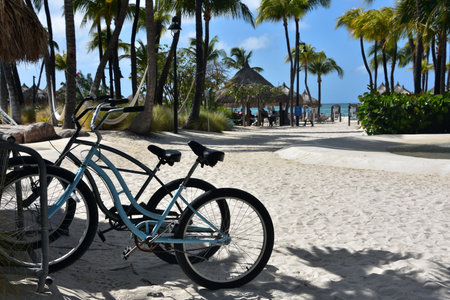 Pair of electric bikes parked on a beach in the sand.の写真素材