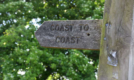 Wood coast to coast sign showing walkers the way.の写真素材