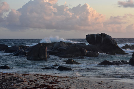 Stunning view of waves crashing on rocks in the ocean in Aruba.