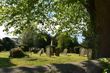 Old historic cemetery in a church yard in the English countryside.