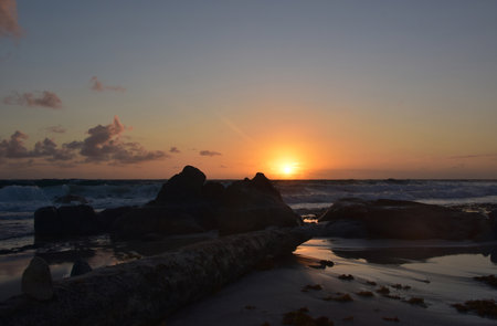 Lovely seascape with silhouetted rocks and crashing waves in Aruba.