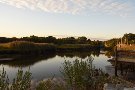 Scenic look at marsh grass reflecting in a river in Duxbury.