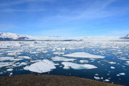 Brilliant blue skies over an icey lagoon in Jokulsarlon in Iceland.