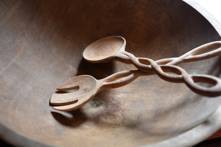 Carved twist in salad tongs made out of wood for salad.の写真素材