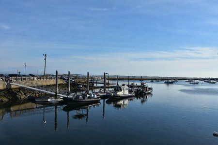 View of boats docked in Plymouth Harbor in the summer time.