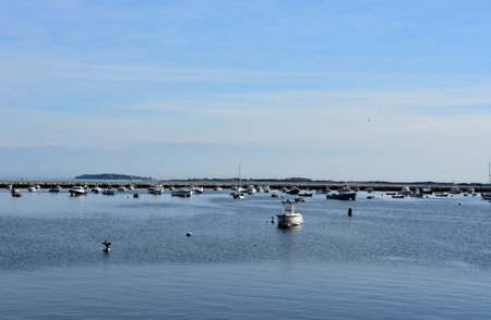 Scenic Plymouth harbor with boats moored and anchored in the bay.