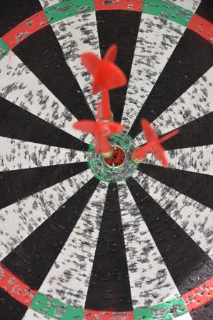 Trio of darts in the center of a target.