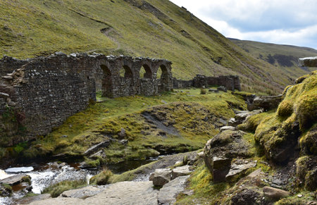 Spectacular stone arches in Gunnerside glenn ruins in rural england.の写真素材