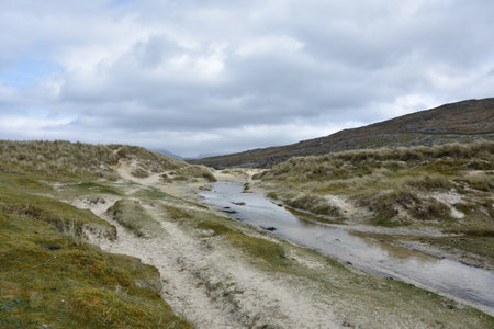 Stunning landscape with machair sand dunes and winding water way.