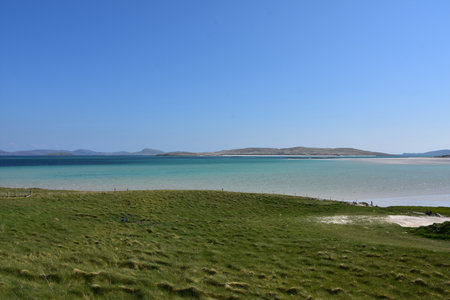 Scenic blue skies over the waters of Vatersay of Scotland.