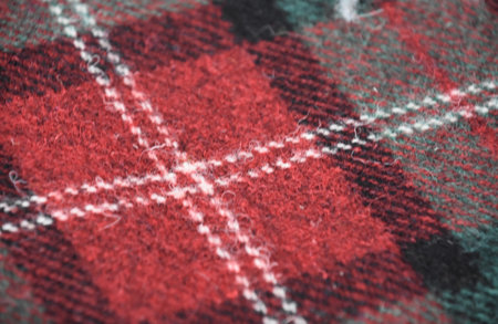 Red and white woven wool tartan cloth designed in Scotland.