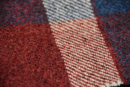 Textile made from red white and blue wool threads in Scotland.