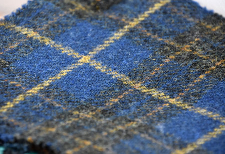 Blue and yellow woven plaid fabric textile in Scotland.