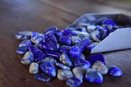 Lapis Is a beautiful natural gemstone on a wooden floorの写真素材
