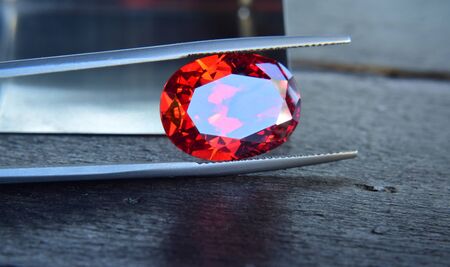 ruby Is a beautiful red gemstone on a wooden floorの写真素材