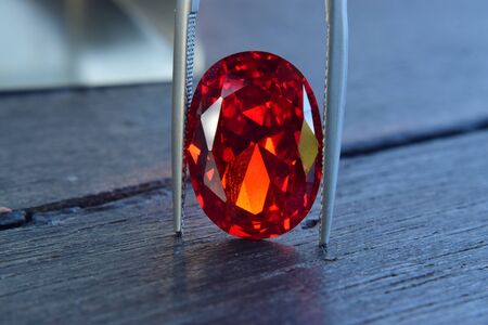 ruby Is a beautiful red gemstone on a wooden floorの写真素材