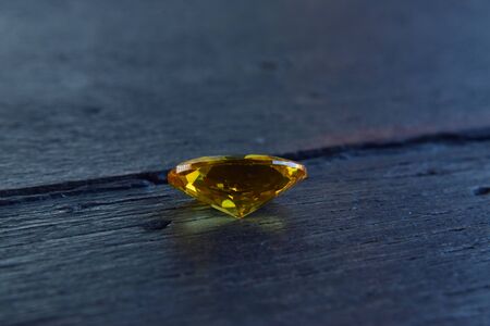 Yellow gem Beautiful on the wooden floorの写真素材