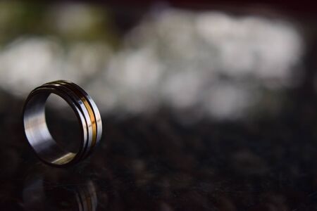 Two wedding rings Luxurious gold and silver On the wooden floorの写真素材