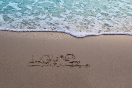 On the sand, there was a letter saying love