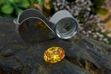 Yellow gem Beautiful on the wooden floorの写真素材