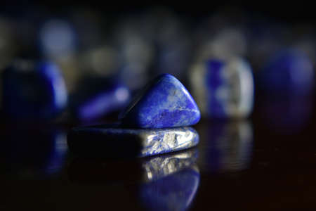Lapis Is a beautiful natural gemstone on a wooden floorの写真素材