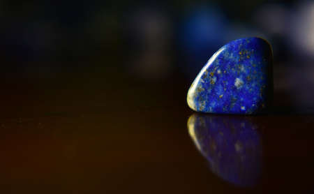 Lapis Is a beautiful natural gemstone on a wooden floorの写真素材