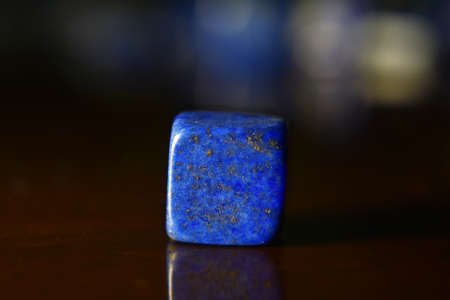Lapis Is a beautiful natural gemstone on a wooden floorの写真素材
