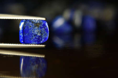 Lapis Is a beautiful natural gemstone on a wooden floorの写真素材