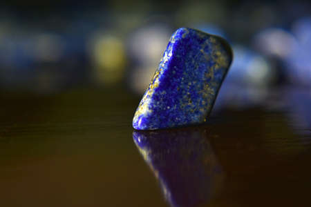 Lapis Is a beautiful natural gemstone on a wooden floor