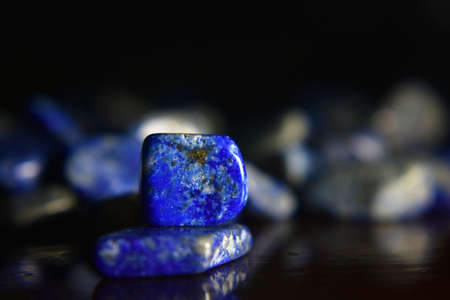 Lapis Is a beautiful natural gemstone on a wooden floorの写真素材