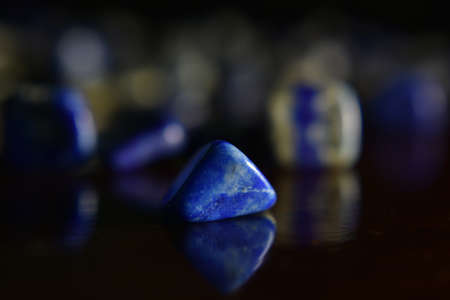 Lapis Is a beautiful natural gemstone on a wooden floorの写真素材
