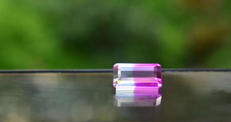 Rectangular pink gemstone Laid on the floor with reflectionの写真素材